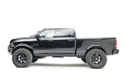 Fab Fours Open Fender Flares on a black Ram 2500 crew cab, driver-side profile view, showing the front and rear open fender flares and raised wheel openings