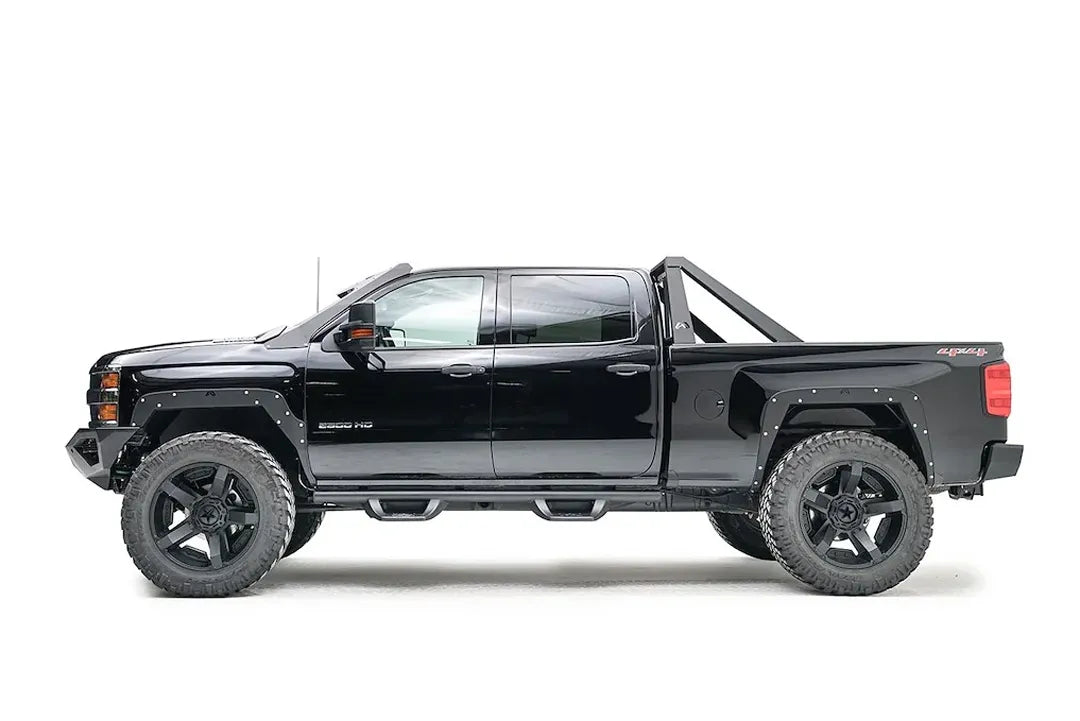 Fab Fours Open Fender System on a black Chevrolet 2500HD, driver-side profile view, showing the open front and rear fenders and raised wheel openings