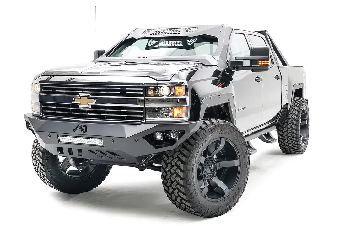 Fab Fours Open Fender System on a silver Chevrolet 2500HD, front three-quarter view from the driver side, showing the open front fenders, raised wheel openings and fender trim