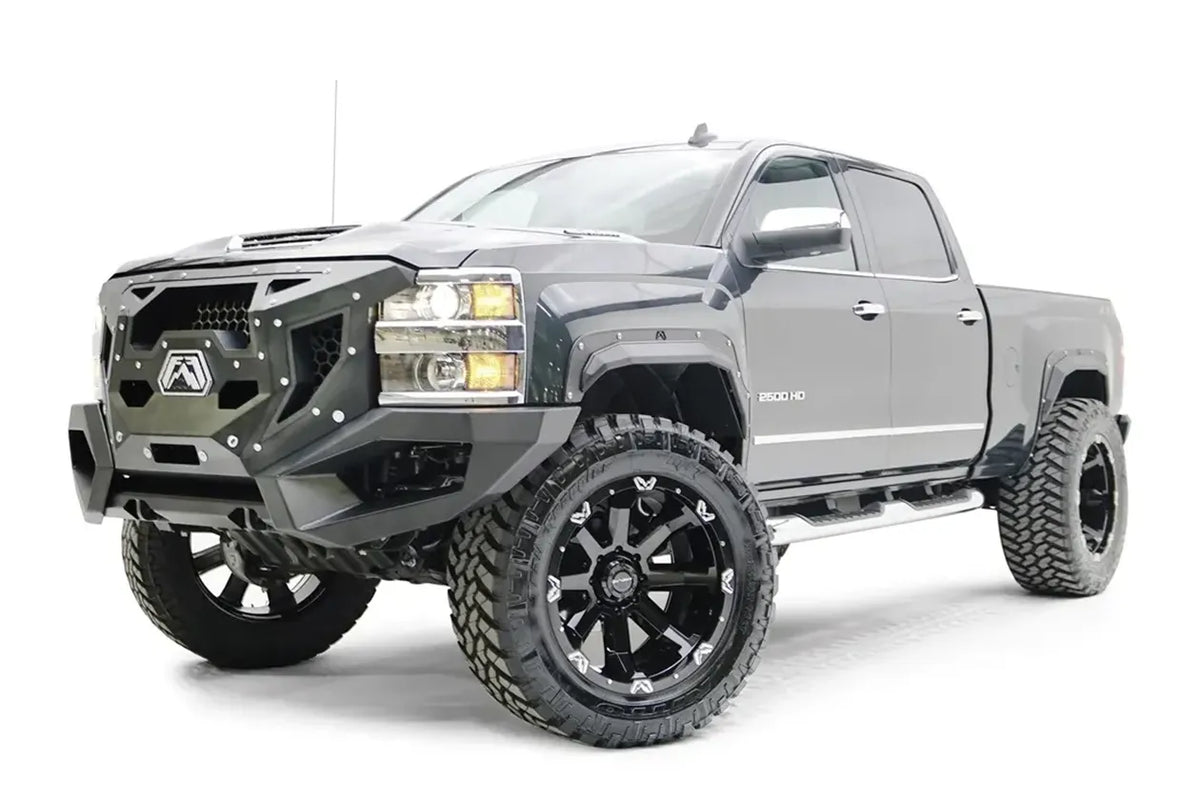 Fab Fours Open Fender Flares on a gray Chevrolet 2500HD, front three-quarter view from the driver side, showing the open front fender flare, bolt detail and tire clearance