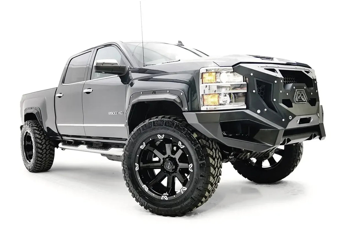 Fab Fours Open Fender Flares on a gray Chevrolet 2500HD, front three-quarter view from the passenger side, showing the open front fender flare, bolt detail and tire clearance