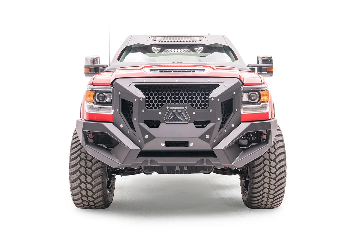 Lifted red GMC Sierra 3500HD with Fab Fours open fender system, front view, with Fab Fours Grumper front bumper and cab roof visor