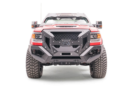 Lifted red GMC Sierra 3500HD with Fab Fours open fender system, front view, with Fab Fours Grumper front bumper and cab roof visor