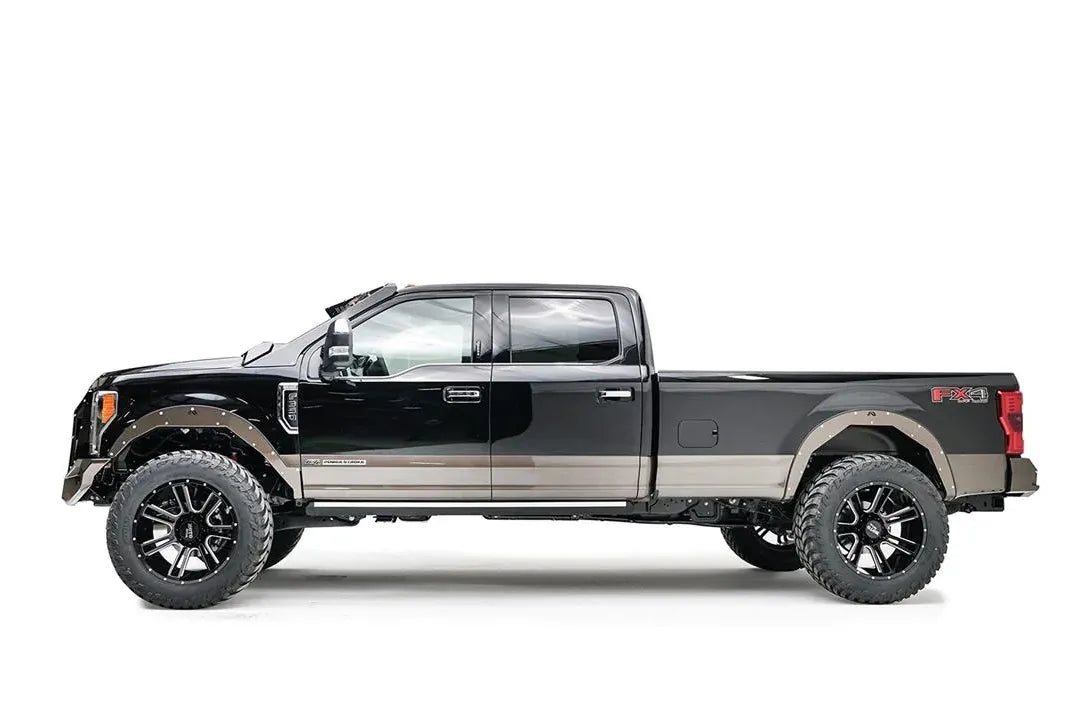 Fab Fours Open Fender System on a black Ford F-250 Super Duty, driver-side profile view, showing the open front and rear fenders and raised wheel openings