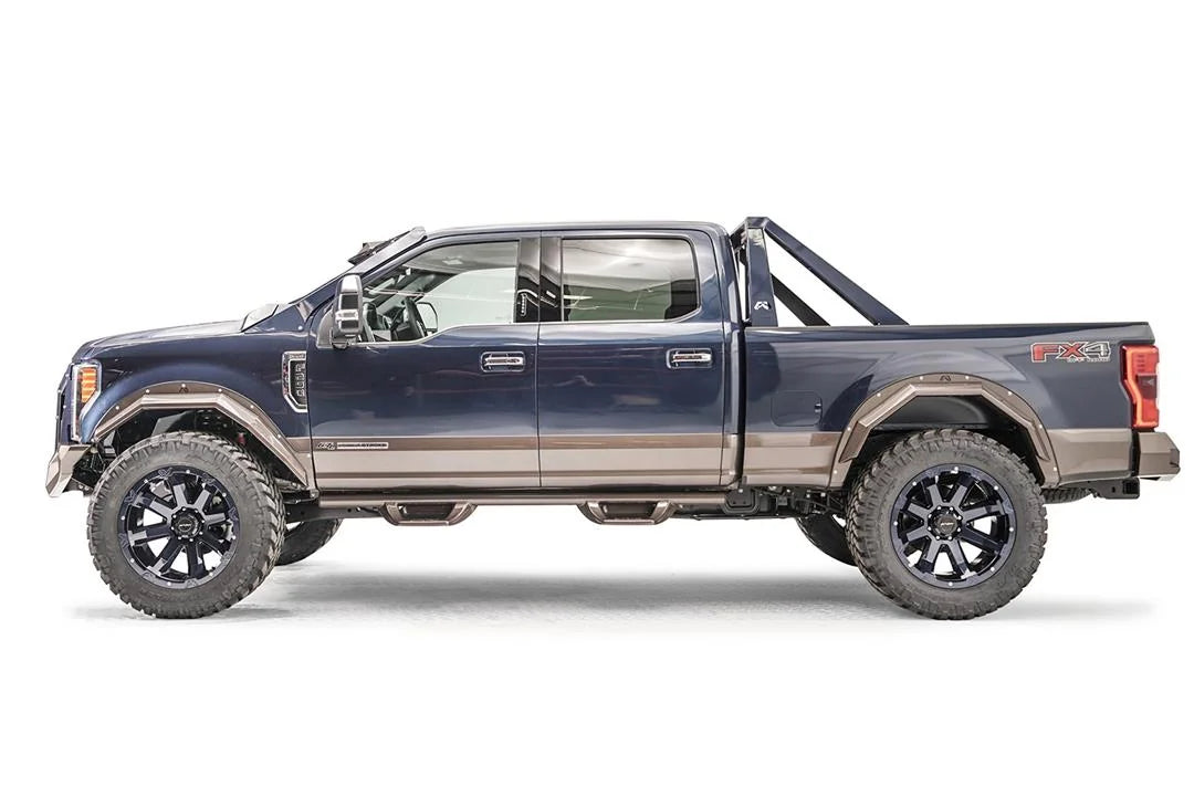Fab Fours open fender flares in bronze on a lifted blue two-tone Ford F-250 Super Duty with sport bar, driver-side profile view
