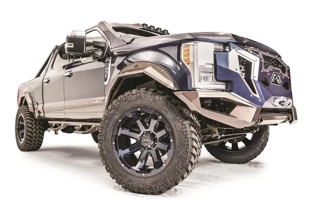 Fab Fours bronze open fender flares on a lifted blue two-tone Ford F-250 Super Duty, passenger-side front three-quarter view, with Fab Fours Grumper front bumper