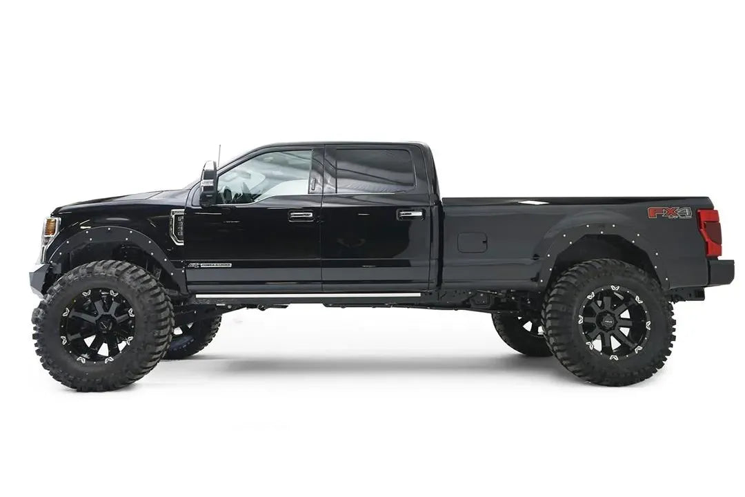 Fab Fours Open Fender System on a black Ford F-250 Super Duty, driver-side profile view, showing the open front and rear fenders and raised wheel openings