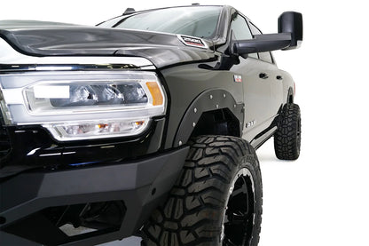 Fab Fours Open Fender System on a black Ram 2500 crew cab, close-up of the front fender from the driver side, showing the open front fender, bolt-on trim and tire clearance