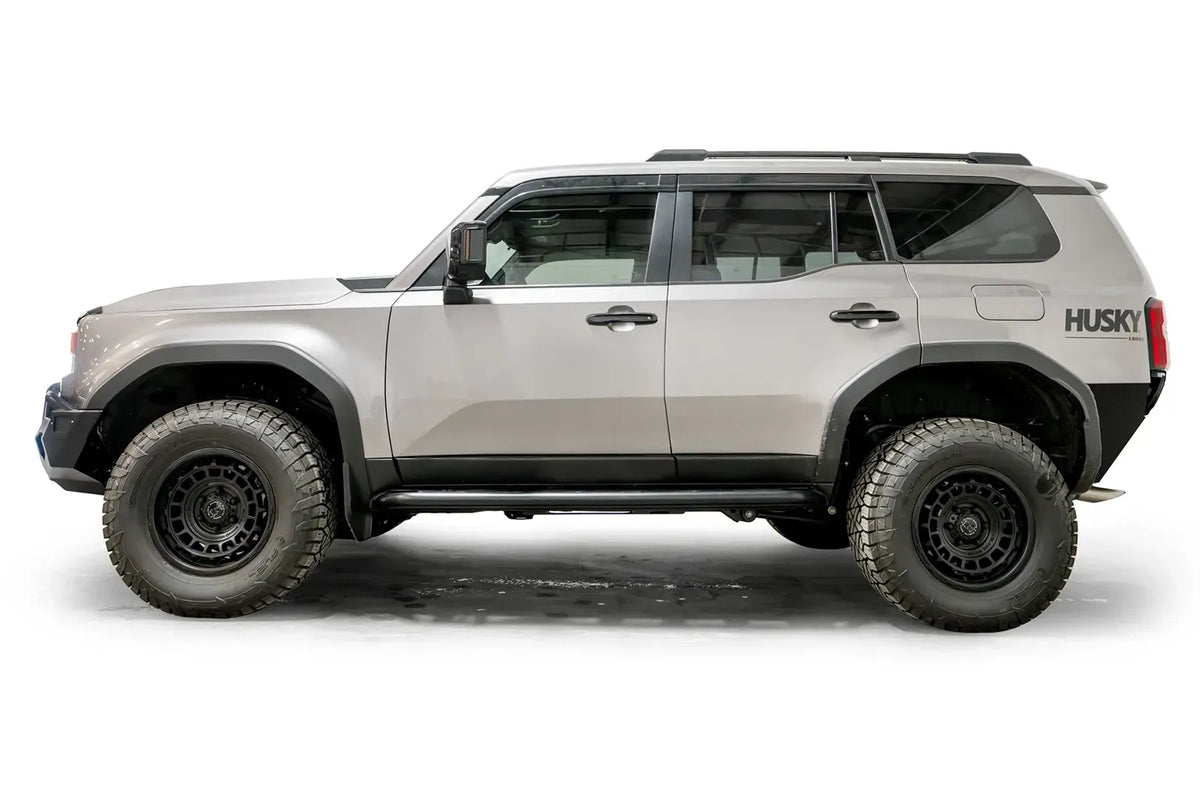 Fab Fours Rock Step slider on a silver Toyota Land Cruiser, driver-side profile