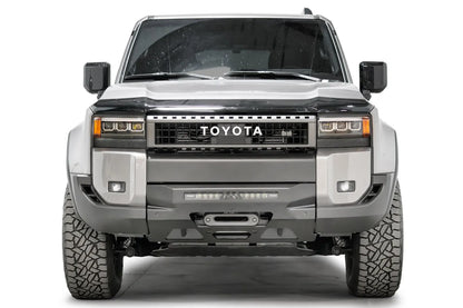 Fab Fours Hidden Winch Mount on a silver Toyota Land Cruiser, front view, showing the low-profile winch plate, LED light bar and winch fairlead