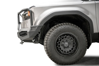 Fab Fours Matrix front bumper with full guard on a silver Toyota Land Cruiser, close-up of the front corner from the side, showing the full guard side tube, bumper end and wheel clearance