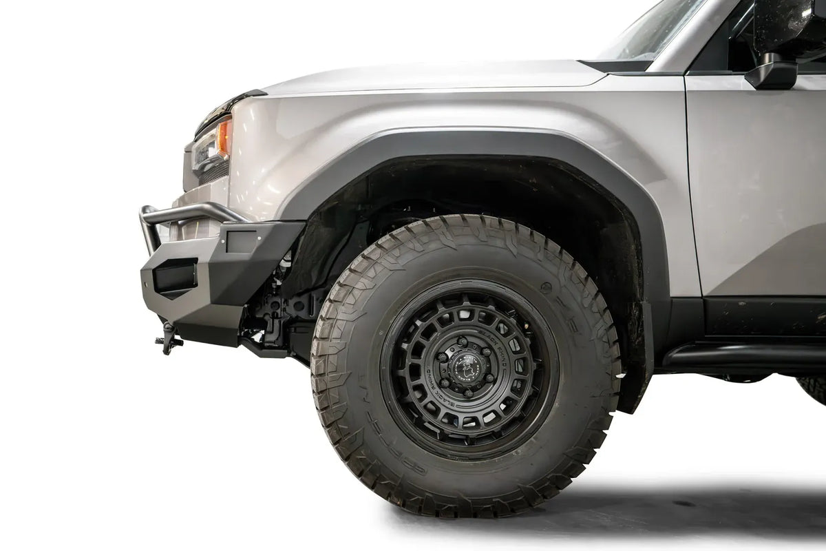 Fab Fours Matrix front bumper with pre-runner guard on a silver Toyota Land Cruiser, close-up of the front corner from the side, showing the pre-runner tube, bumper end and wheel clearance
