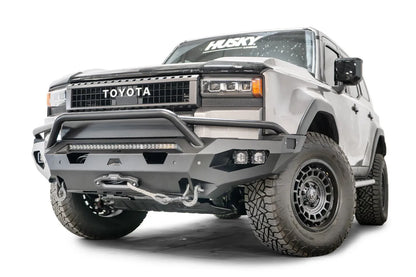 Fab Fours Matrix front bumper with pre-runner guard on a silver Toyota Land Cruiser, front three-quarter view from the driver side, showing the pre-runner hoop, LED light bar, cube lights and winch line