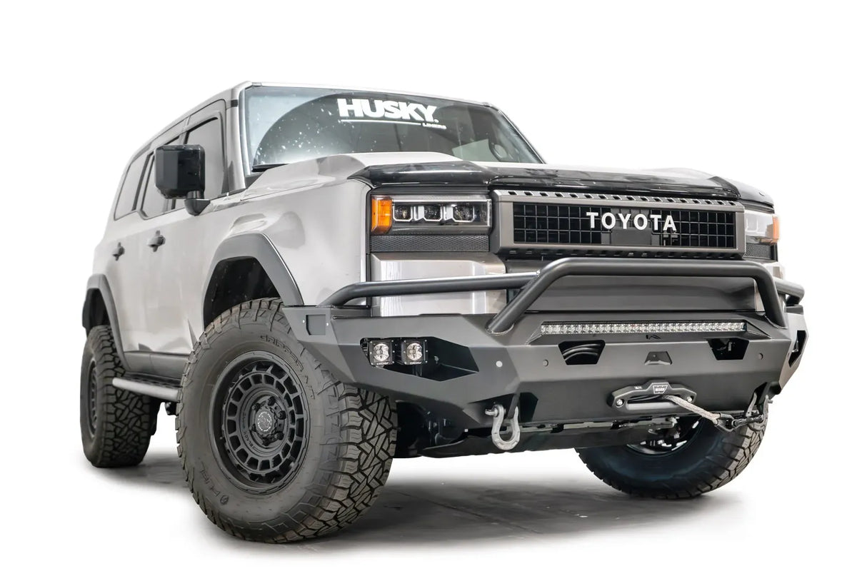 Fab Fours Matrix front bumper with pre-runner guard on a silver Toyota Land Cruiser, front three-quarter view from the passenger side, showing the pre-runner hoop, LED light bar and cube lights