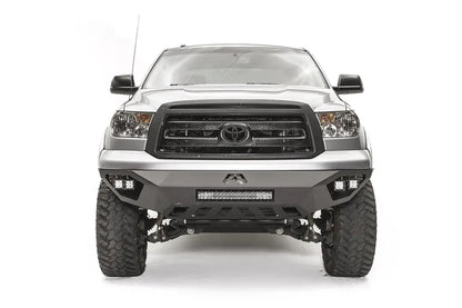 Fab Fours Vengeance front bumper on a silver Toyota Tundra, front view, showing the LED light bar, cube lights and skid plate