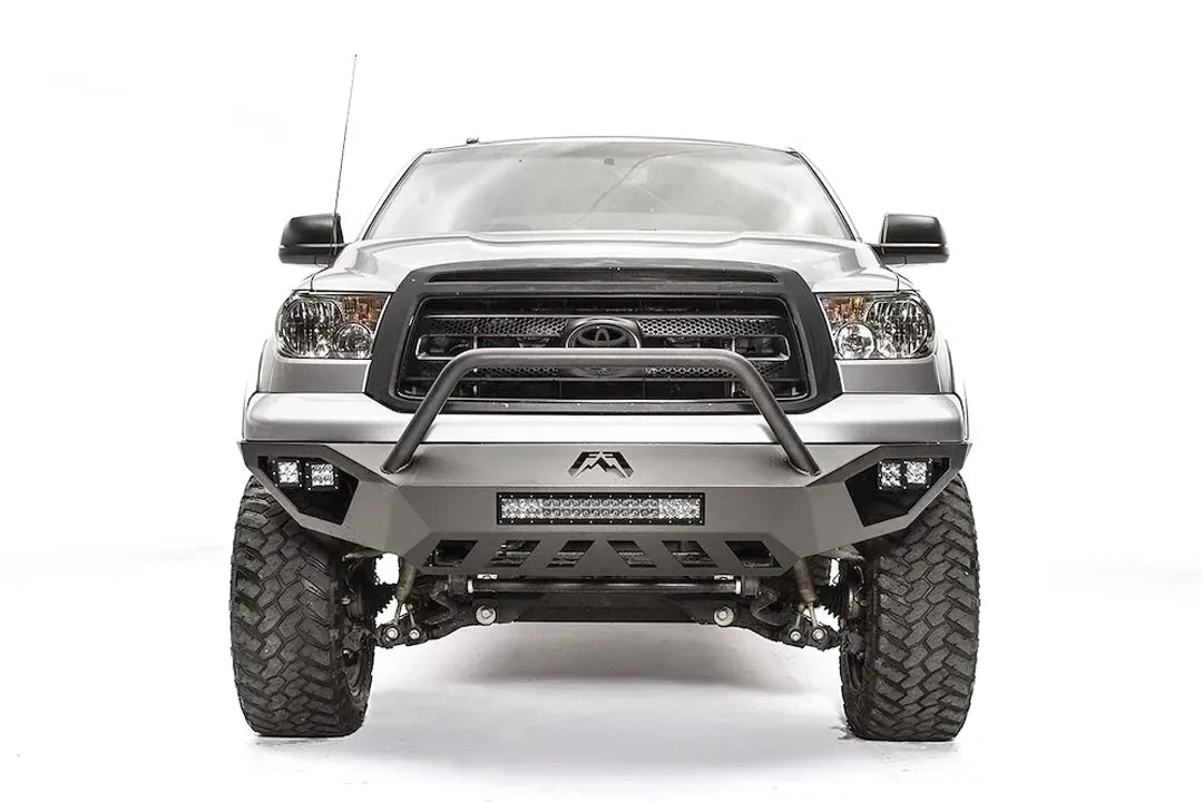 Fab Fours Vengeance front bumper with pre-runner guard on a silver Toyota Tundra, front view, showing the pre-runner hoop, the LED light bar, cube lights and skid plate