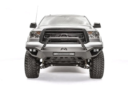 Fab Fours Vengeance front bumper with pre-runner guard on a silver Toyota Tundra, front view, showing the pre-runner hoop, the LED light bar, cube lights and skid plate