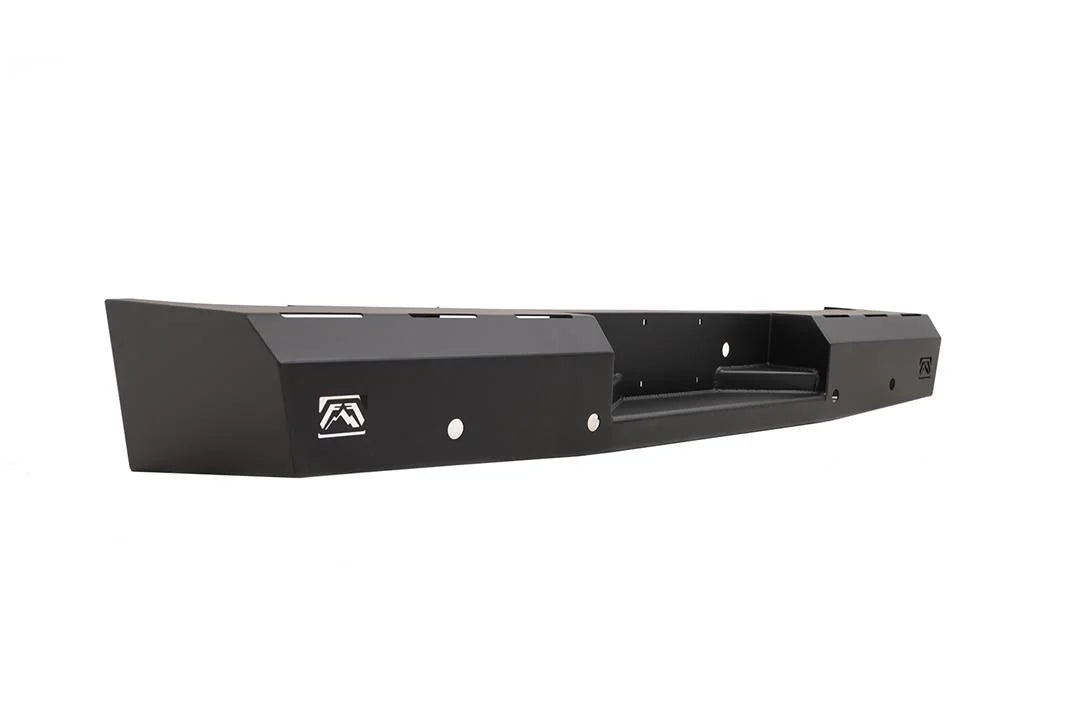 Fab Fours Red Steel rear bumper for the Toyota Tundra, angled view from the driver-side end, showing the faceted end cap, the Fab Fours logo cut-outs and the recessed step with its mounting holes