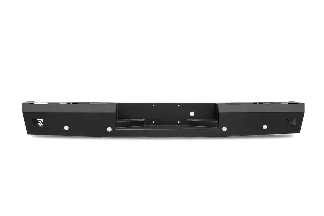 Fab Fours Red Steel rear bumper for the Toyota Tundra in black powder coat, straight-on rear view, showing the recessed center step, the Fab Fours logo cut-outs at each end and the parking sensor openings