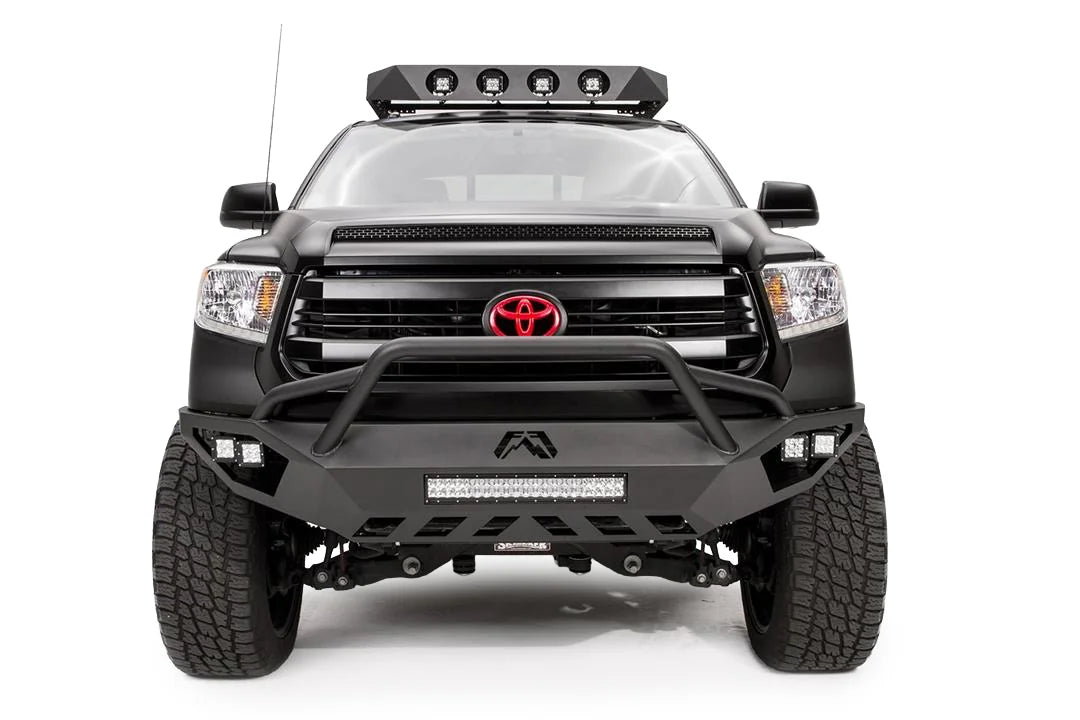 Fab Fours Vengeance front bumper with pre-runner guard on a matte black Toyota Tundra, front view, showing the pre-runner hoop, LED light bar, cube lights and skid plate