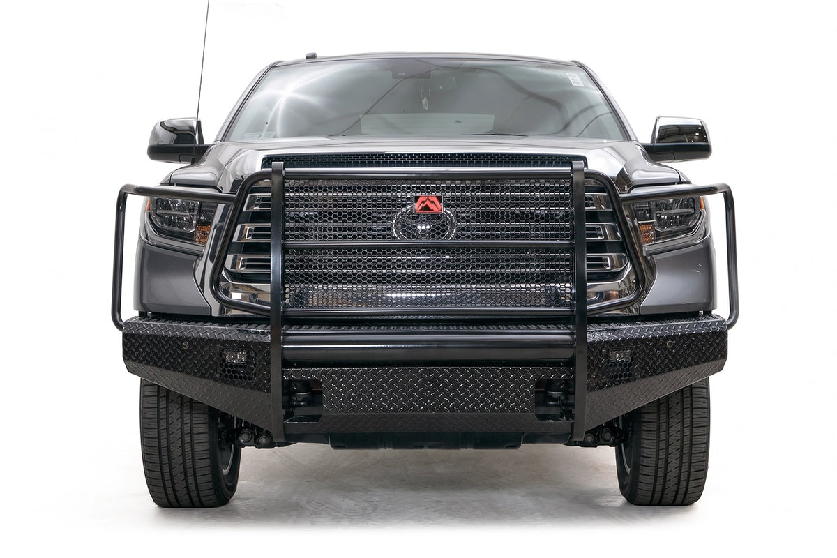 Fab Fours Black Steel diamond plate front bumper with full grille guard on a gray Toyota Tundra