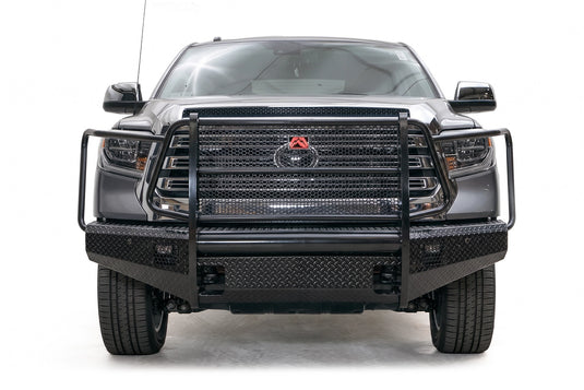 Fab Fours Black Steel diamond plate front bumper with full grille guard on a gray Toyota Tundra