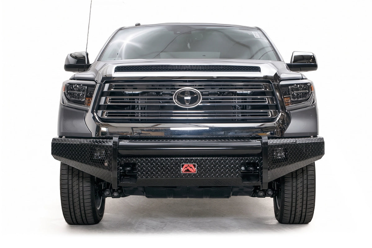 Fab Fours Black Steel diamond plate front bumper on a gray Toyota Tundra