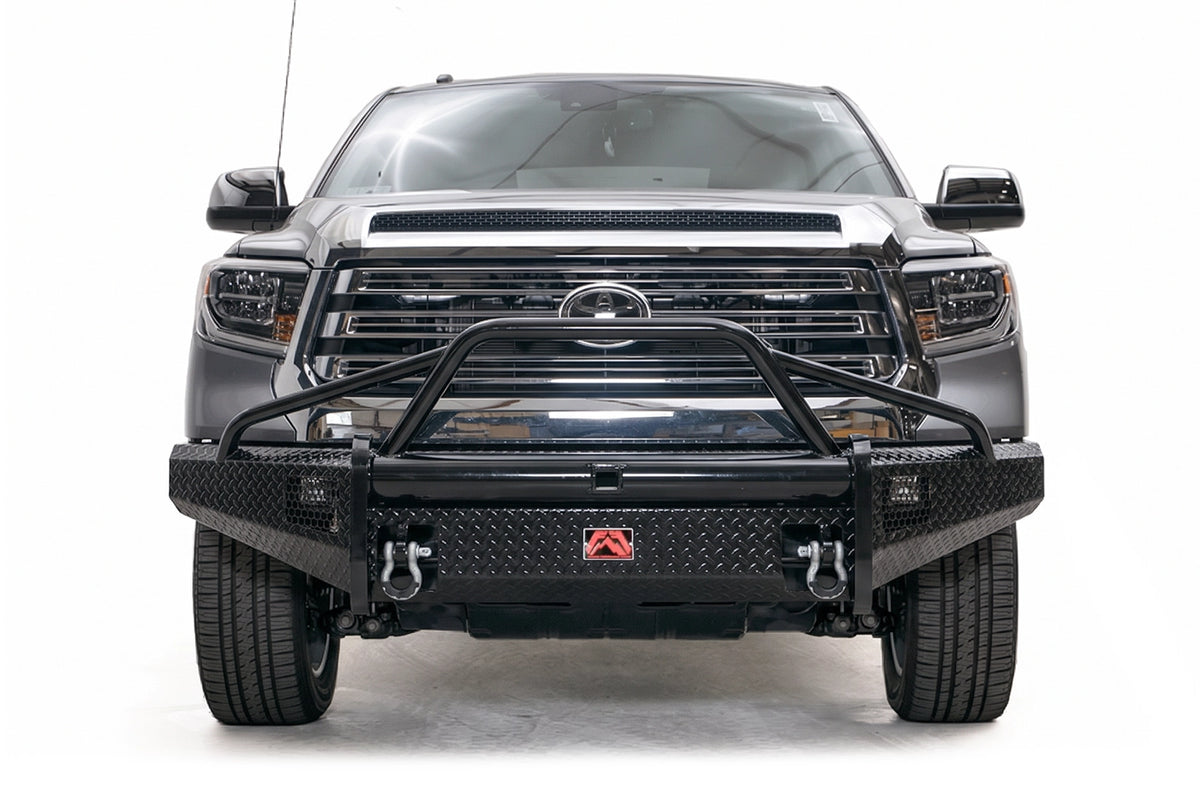 Fab Fours Black Steel diamond plate front bumper with pre-runner guard on a gray Toyota Tundra
