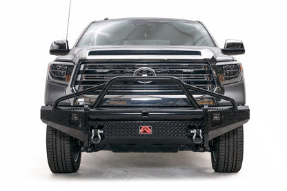 Fab Fours Black Steel diamond plate front bumper with pre-runner guard on a gray Toyota Tundra