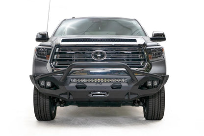 Fab Fours Matrix front bumper with pre-runner guard on a gray Toyota Tundra, straight-on front view, showing the pre-runner hoop, LED light bar, and center winch mount