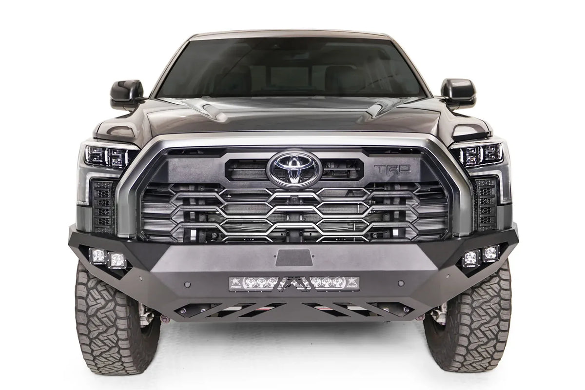 Fab Fours Vengeance front bumper on a gray Toyota Tundra, straight-on front view, showing the no-guard design, LED light bar, and cube light pods