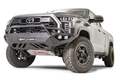 Fab Fours Vengeance front bumper with pre-runner guard on a gray Toyota Tundra, front three-quarter view, showing the pre-runner hoop, LED light bar, and skid plate