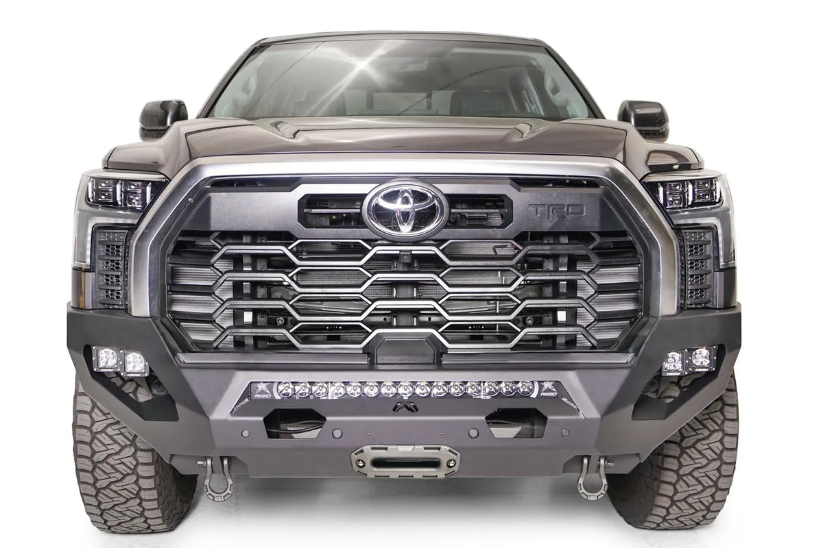 Fab Fours Matrix front bumper on a gray Toyota Tundra, straight-on front view, showing the no-guard design, LED light bar, and center winch fairlead