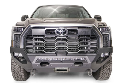 Fab Fours Matrix front bumper on a gray Toyota Tundra, straight-on front view, showing the no-guard design, LED light bar, and center winch fairlead