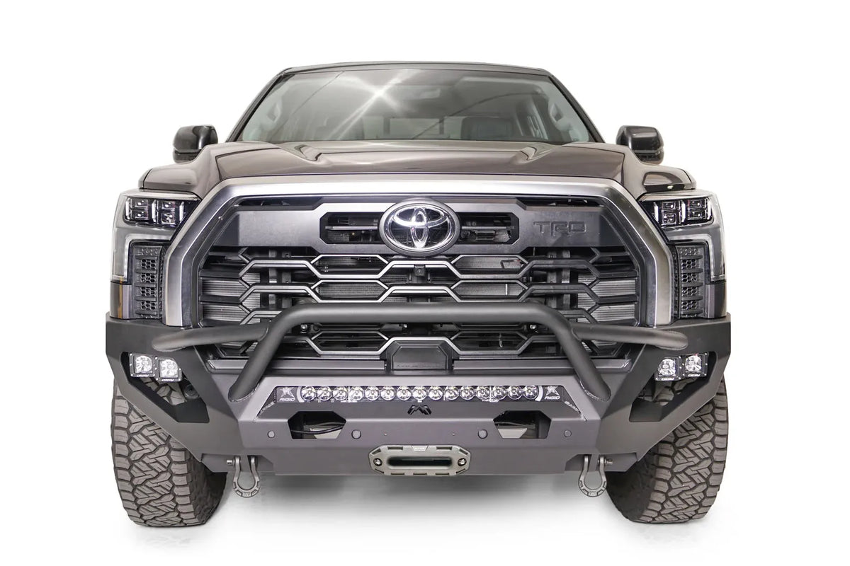 Fab Fours Matrix front bumper with pre-runner guard on a gray Toyota Tundra, straight-on front view, showing the pre-runner hoop, LED light bar, and center winch fairlead