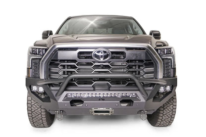 Fab Fours Matrix front bumper with pre-runner guard on a gray Toyota Tundra, straight-on front view, showing the pre-runner hoop, LED light bar, and center winch fairlead