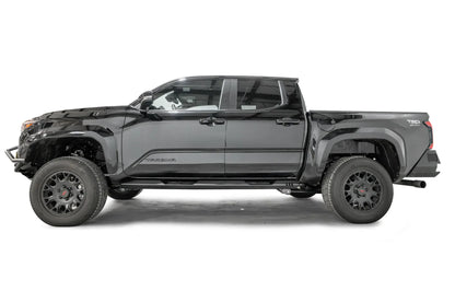 Fab Fours step slider on a black four-door Toyota Tacoma TRD Sport, driver-side profile