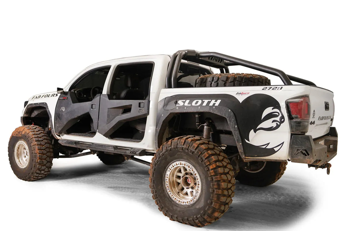 Fab Fours sport rack on a lifted white Toyota Tacoma TRD Pro with spare tire in the bed and Fab Fours doors, driver-side rear three-quarter view
