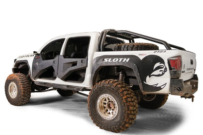 Fab Fours sport rack on a lifted white Toyota Tacoma TRD Pro with spare tire in the bed and Fab Fours doors, driver-side rear three-quarter view