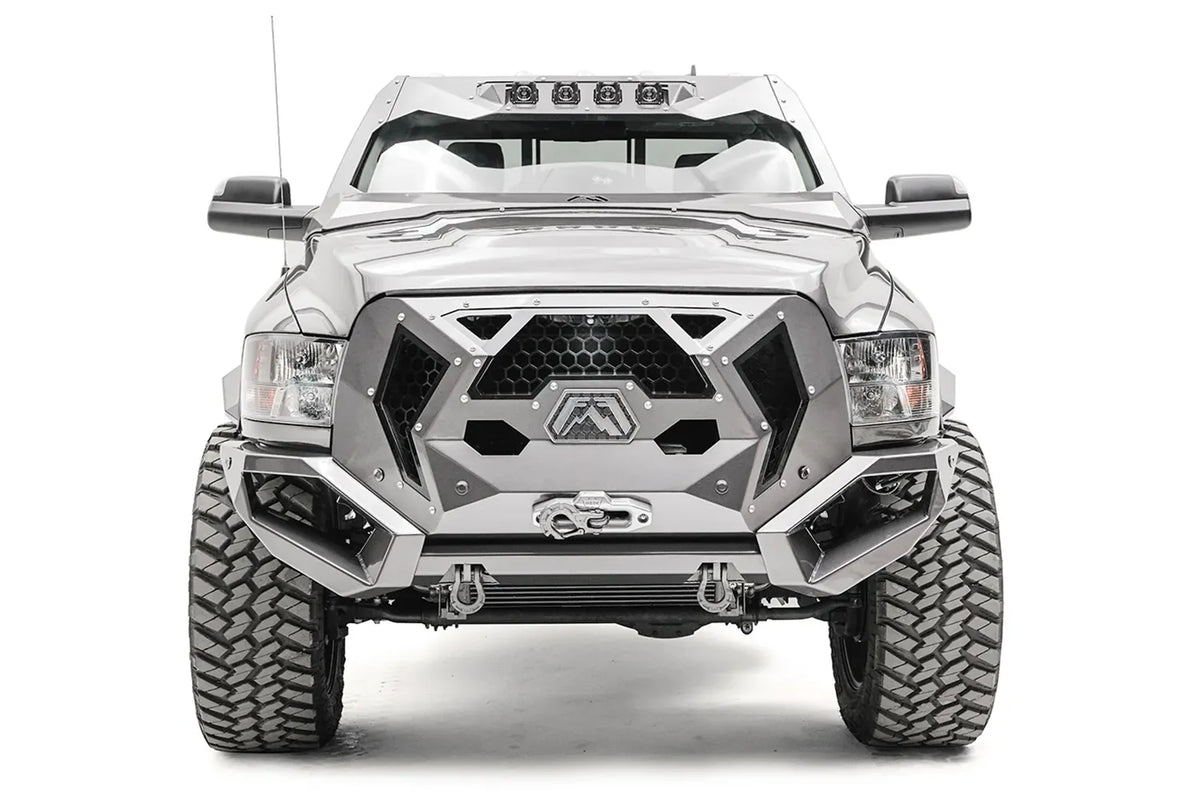 Fab Fours ViCowl on a silver Ram 2500, straight-on front view, showing the windshield frame cover, four light pods, and symmetrical cowl shape