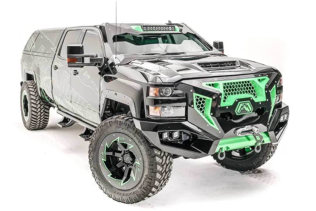 Fab Fours ViCowl on a black and green wrapped Chevrolet Silverado 2500 HD, front three-quarter view, showing the windshield frame cover, integrated light bar, and A-pillar wrap