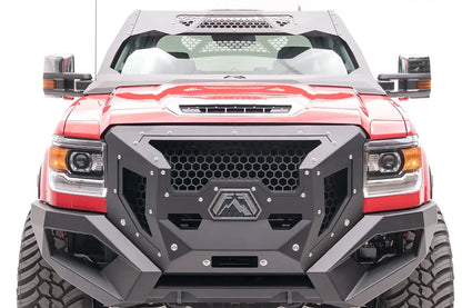 Fab Fours ViCowl on a lifted red GMC Sierra HD, front view, with the steel windshield cowl above a matching Fab Fours front bumper and honeycomb grille guard