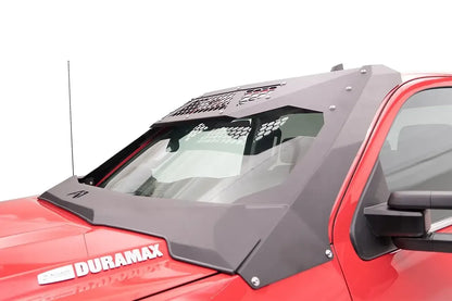 Fab Fours ViCowl on a red GMC Sierra 2500 HD Duramax, driver-side view, showing the matte black steel cowl and roof visor with honeycomb vent panels framing the windshield