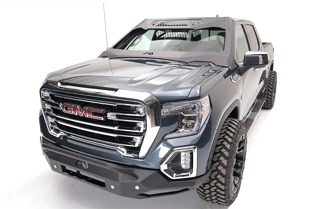 Fab Fours ViCowl on a lifted gray GMC Sierra 1500, front driver-side view, with the steel windshield cowl, honeycomb vents and matching Fab Fours front bumper