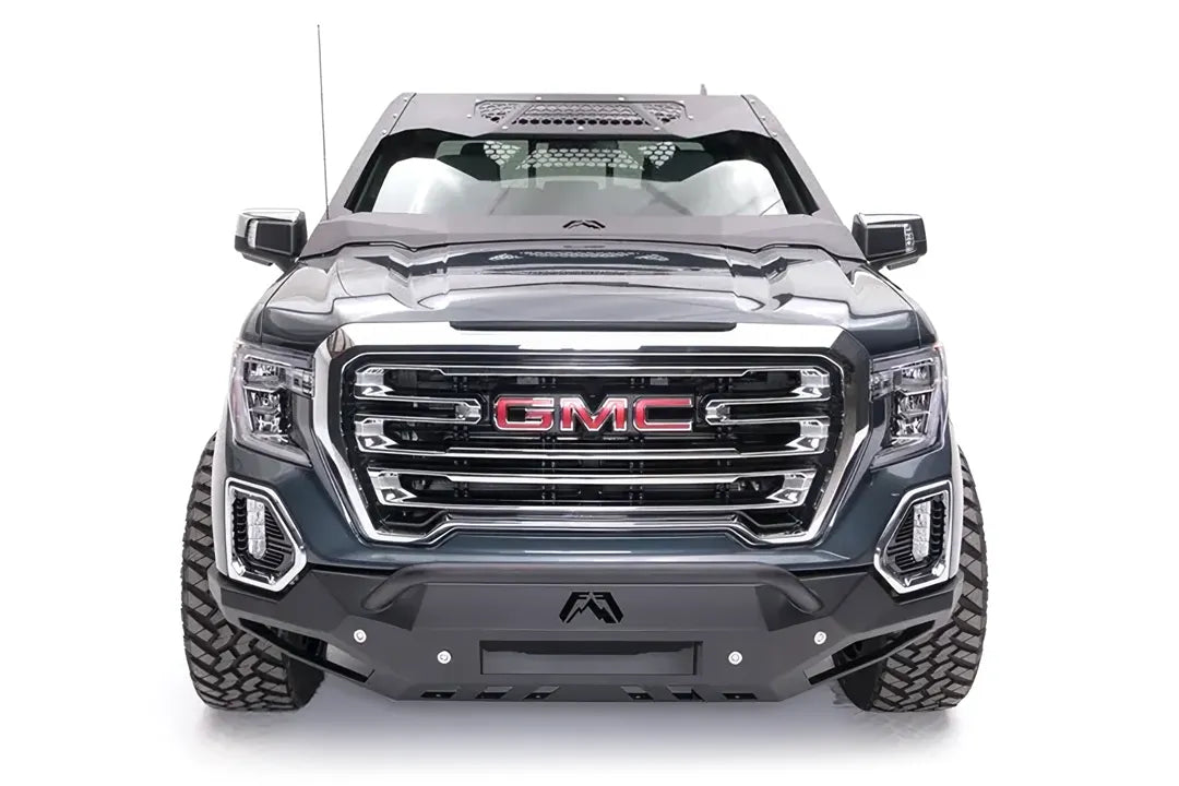 Fab Fours ViCowl on a gray GMC Sierra 1500, front view, showing the matte black steel cowl framing the windshield with honeycomb vent panels, Fab Fours logo and a matching Fab Fours front bumper