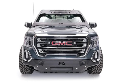 Fab Fours ViCowl on a gray GMC Sierra 1500, front view, showing the matte black steel cowl framing the windshield with honeycomb vent panels, Fab Fours logo and a matching Fab Fours front bumper