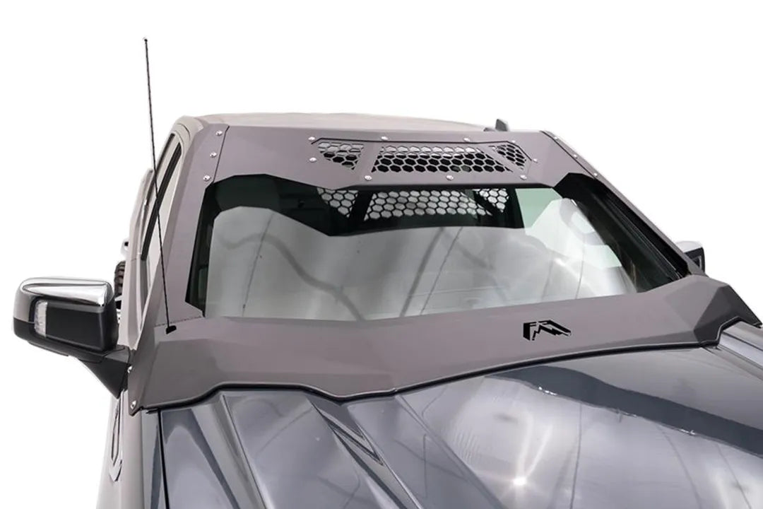 Close-up of the Fab Fours ViCowl on a GMC Sierra 1500, passenger side, showing the formed steel cowl, honeycomb vent panels and Fab Fours logo over the windshield