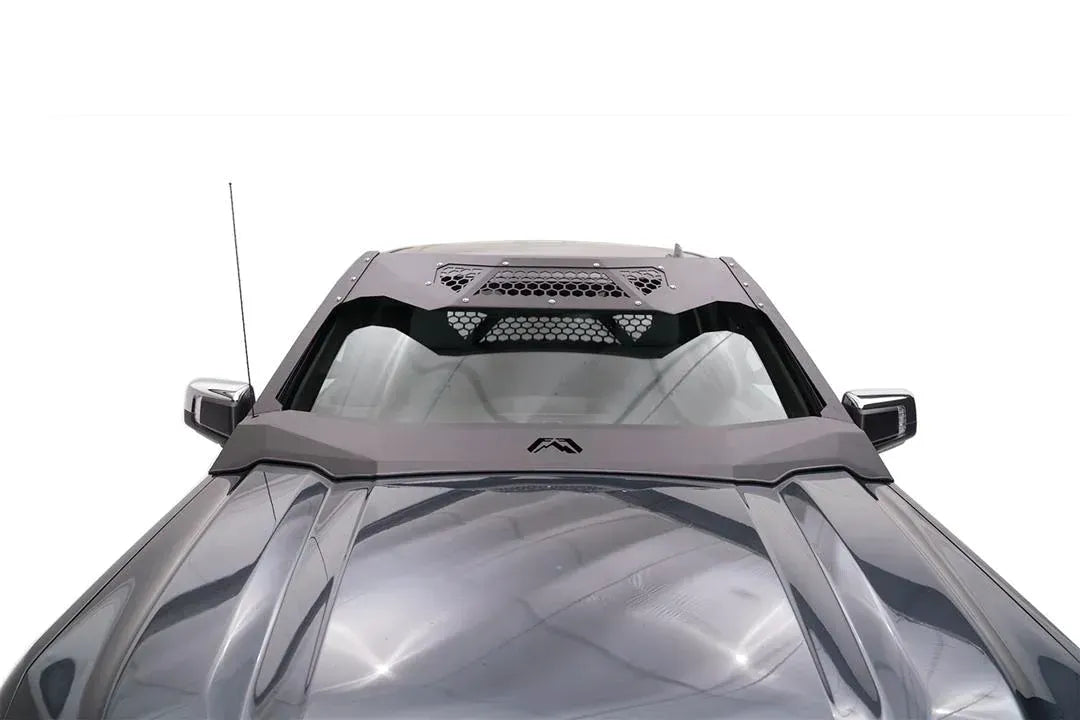 Fab Fours ViCowl on a GMC Sierra 1500, elevated front view over the hood, showing the angular steel cowl, honeycomb mesh vent panels and Fab Fours logo at the base of the windshield