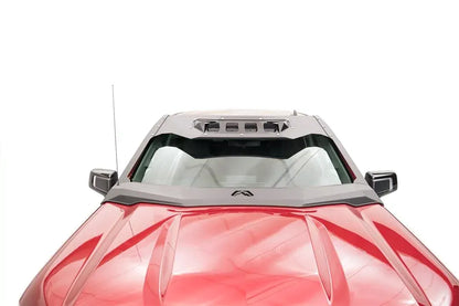 Fab Fours ViCowl on a red Chevrolet Silverado 1500, close-up over the hood, showing the windshield frame cover, light pod openings, and logo badge