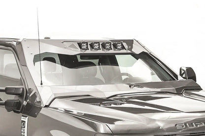 Close-up of the Fab Fours ViCowl on a Ford Super Duty, showing four cube lights in the top light bar, steel A-pillar covers and the Fab Fours logo on the cowl over the hood